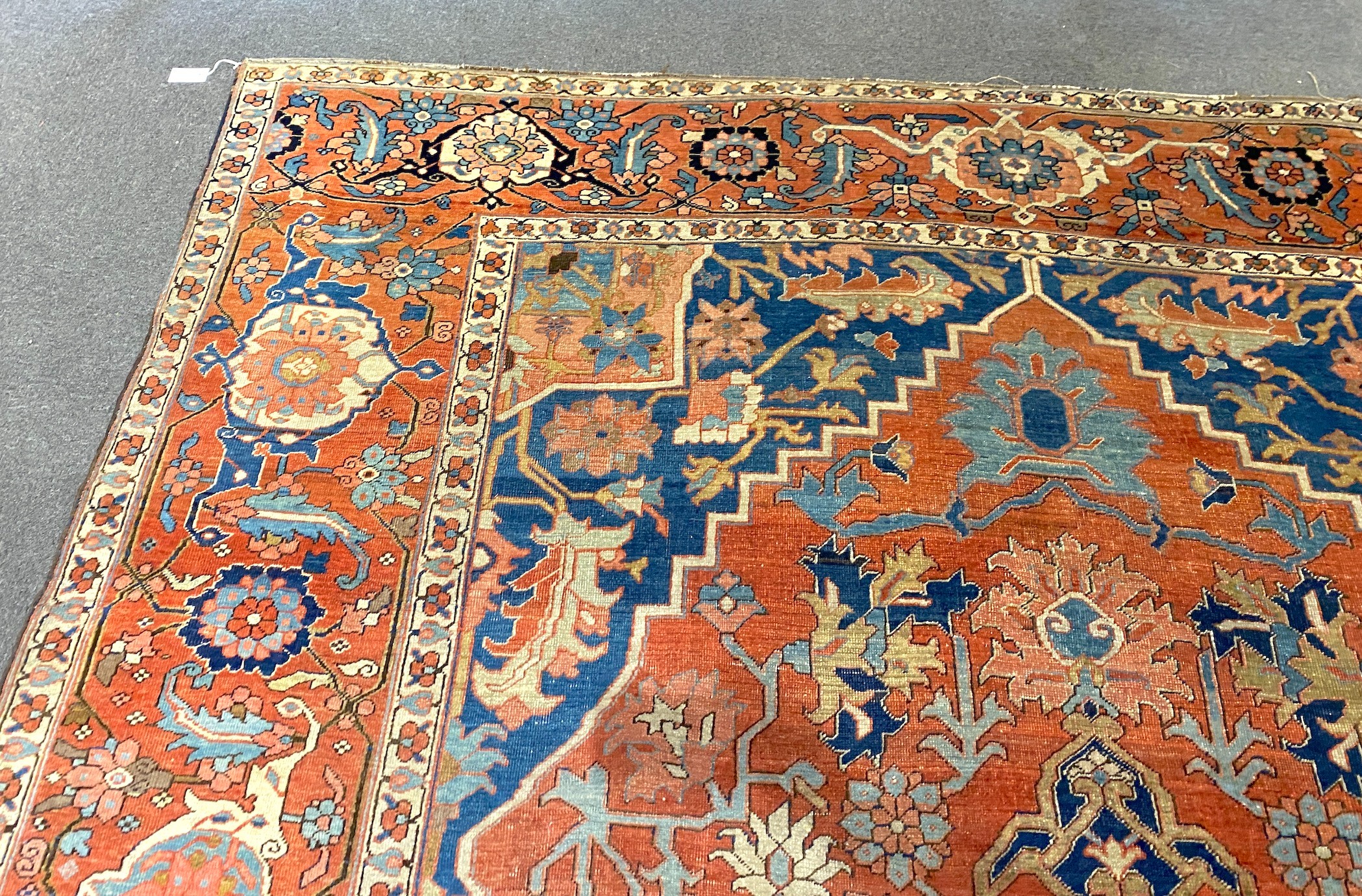An antique Heriz brick red ground carpet, 370cm x 290cm